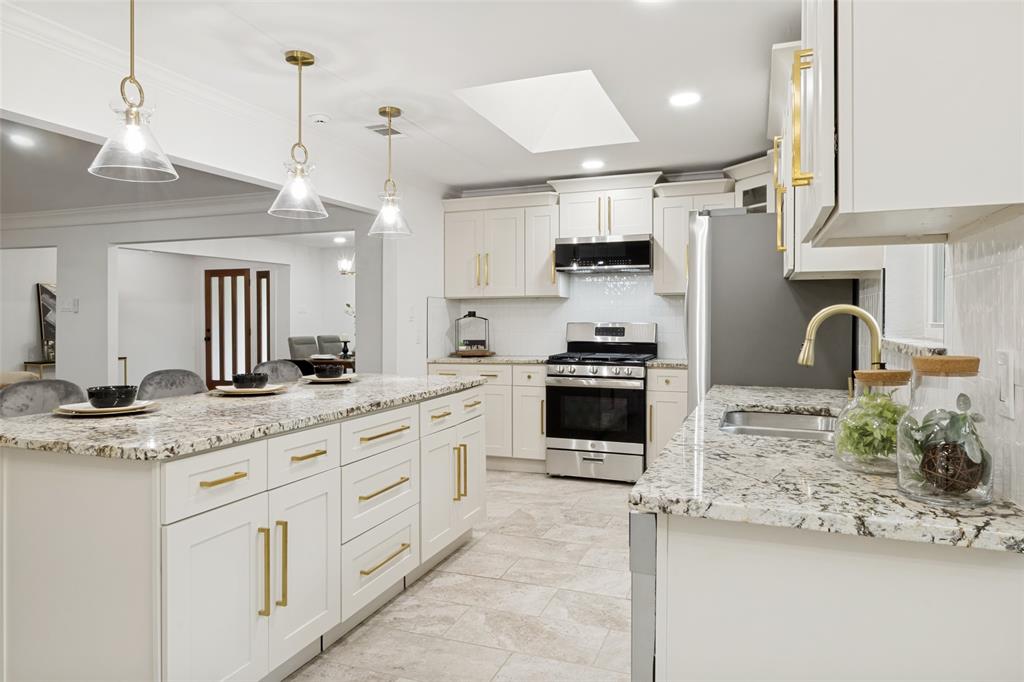 9552 Timberleaf Drive Dallas, TX 75243 - Photo 14 of 32 a kitchen with stainless steel appliances kitchen island granite countertop a sink and cabinets