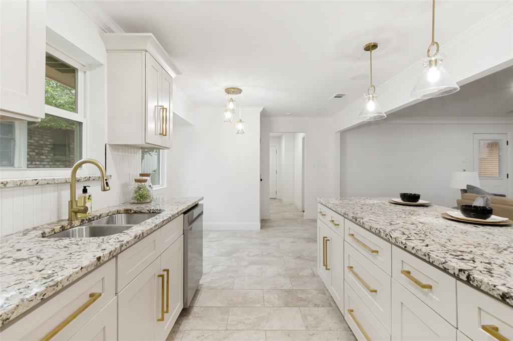 9552 Timberleaf Drive Dallas, TX 75243 - Photo 15 of 32 a kitchen with granite countertop a sink and a refrigerator