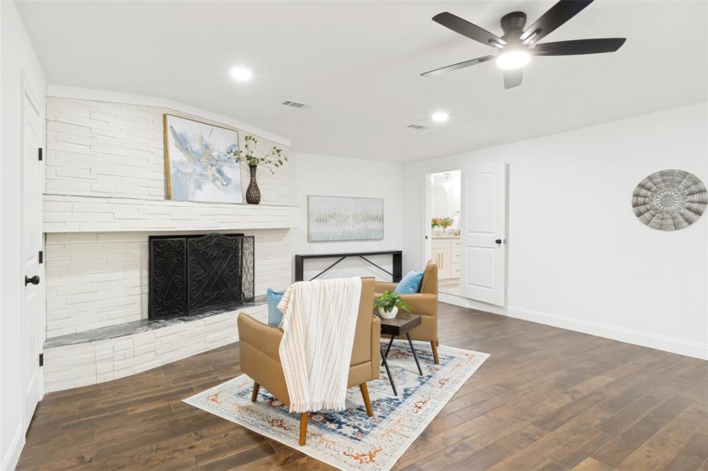 9552 Timberleaf Drive Dallas, TX 75243 - Photo 20 of 32 a living room with furniture and a fireplace