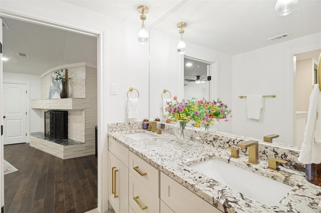 9552 Timberleaf Drive Dallas, TX 75243 - Photo 21 of 32 a bathroom with a granite countertop sink and a mirror
