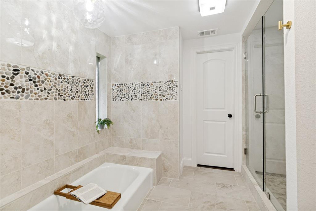 9552 Timberleaf Drive Dallas, TX 75243 - Photo 22 of 32 a bathroom with a tub and shower