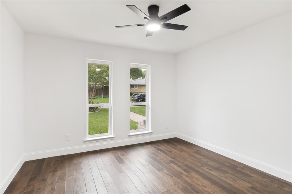 9552 Timberleaf Drive Dallas, TX 75243 - Photo 24 of 32 a view of an empty room with a window and wooden floor