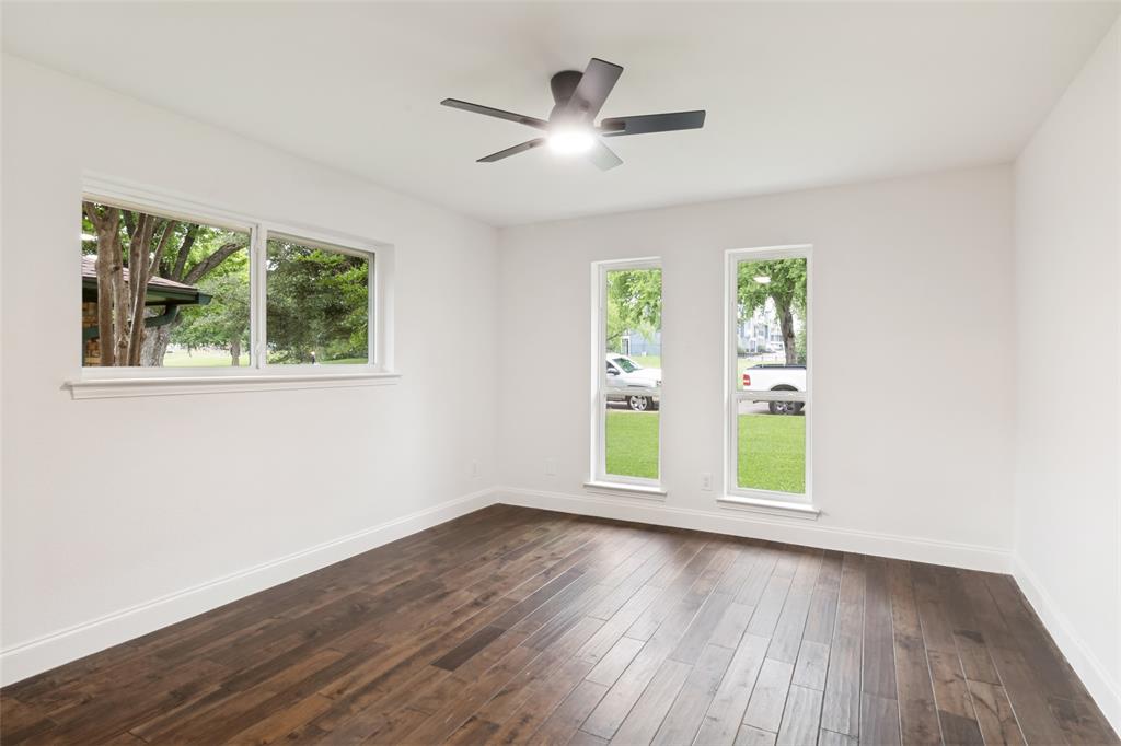 9552 Timberleaf Drive Dallas, TX 75243 - Photo 25 of 32 an empty room with wooden floor and windows