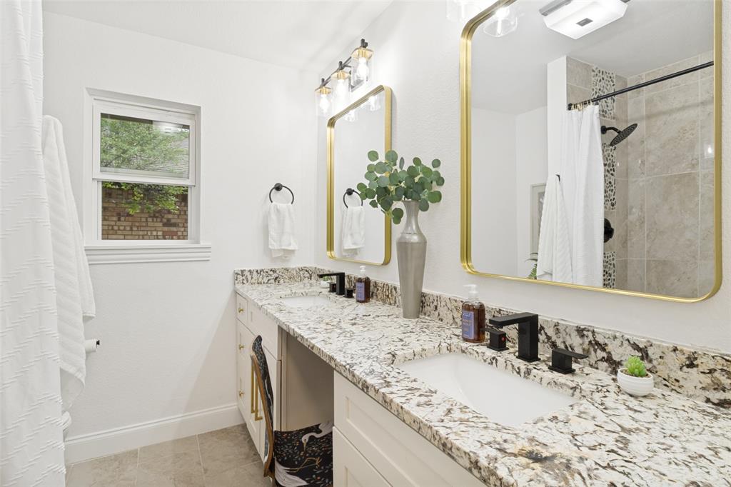 9552 Timberleaf Drive Dallas, TX 75243 - Photo 26 of 32 a bathroom with a granite countertop sink and a mirror