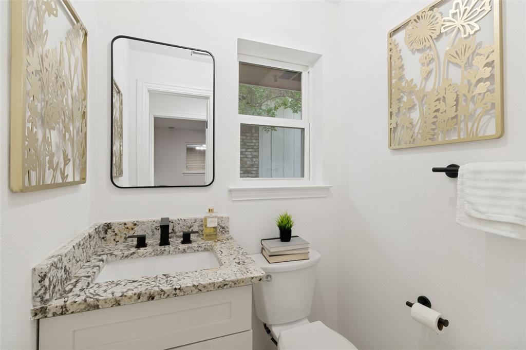 9552 Timberleaf Drive Dallas, TX 75243 - Photo 27 of 32 a bathroom with a granite countertop sink and a mirror with toilet