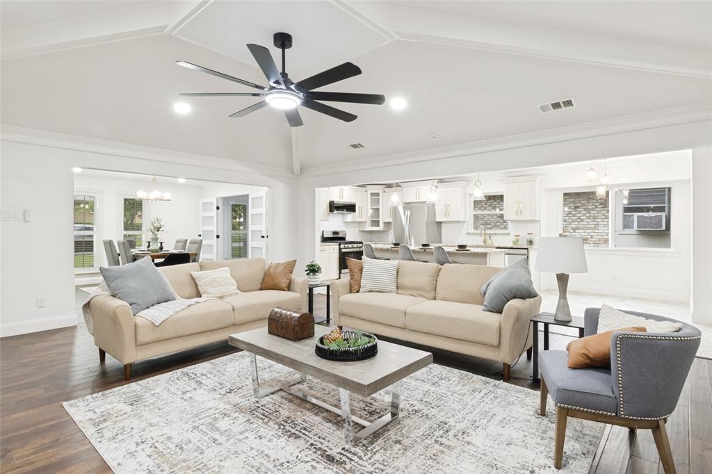 9552 Timberleaf Drive Dallas, TX 75243 - Photo 10 of 32 a living room with furniture a ceiling fan and a rug