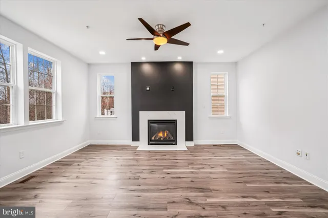 a view of an house with backyard space and a tree