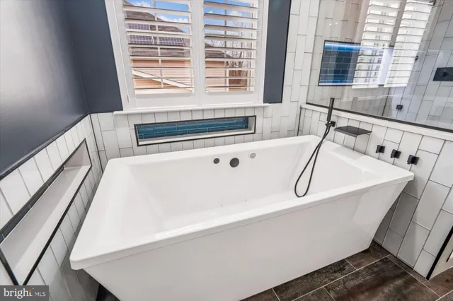 a bathroom with a toilet a sink and a mirror