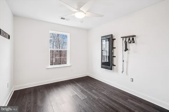 a bathroom with a granite countertop sink mirror and a toilet
