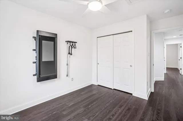 a view of an empty room with wooden floor and a porch