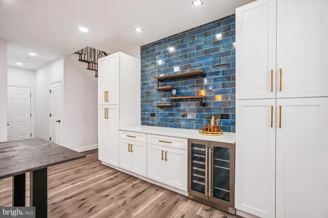 a view of staircase with wooden floor and white walls