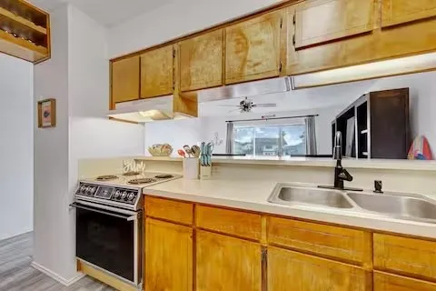 a kitchen with stainless steel appliances granite countertop a sink and cabinets