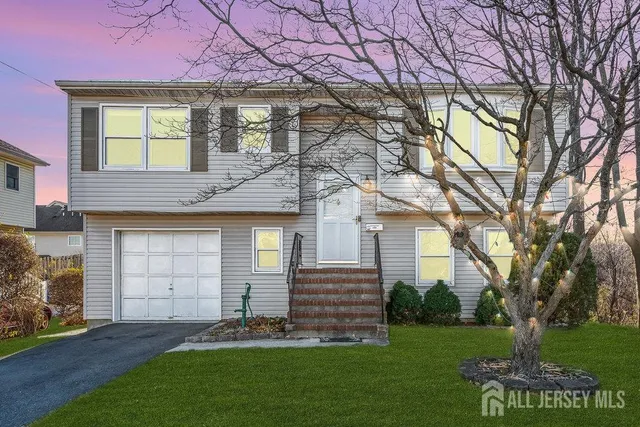 a front view of a house with a garden and yard