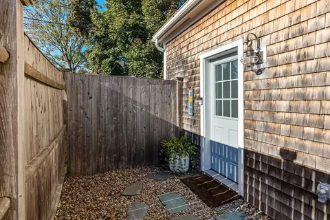 a view of a house with a door and wooden walls