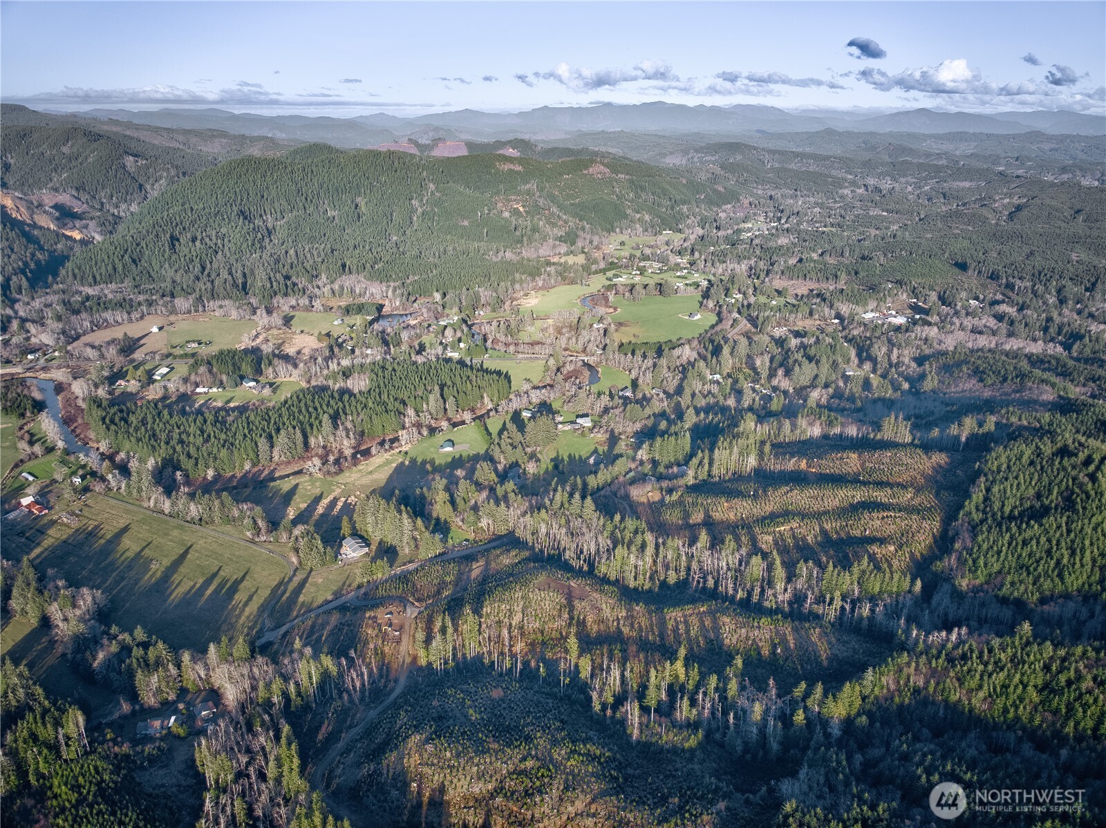 3 South Valley Road Naselle, WA 98638 - Photo 15 of 19 a view of a lake with a building in the background