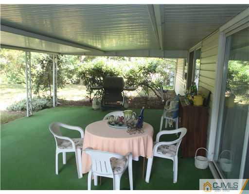 21 Rumson Road Kendall Park, NJ 08824 - Photo 14 of 16 a dining room with furniture and garden view