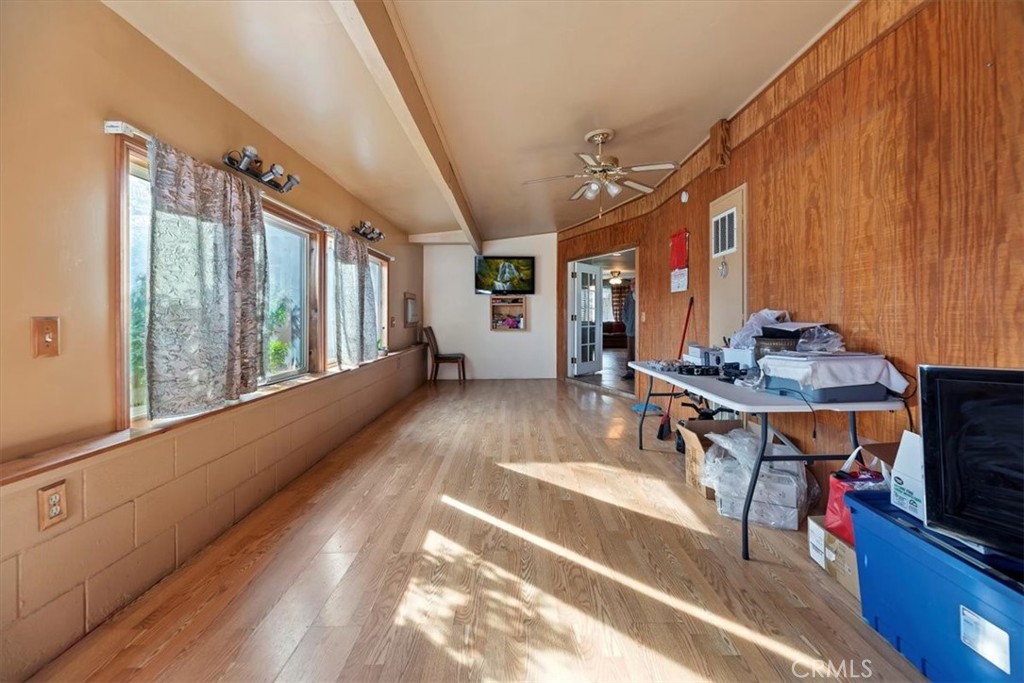 13285 Mesquite Road Apple Valley, CA 92308 - Photo 12 of 33 a view of a living room and kitchen with furniture wooden floor and a rug