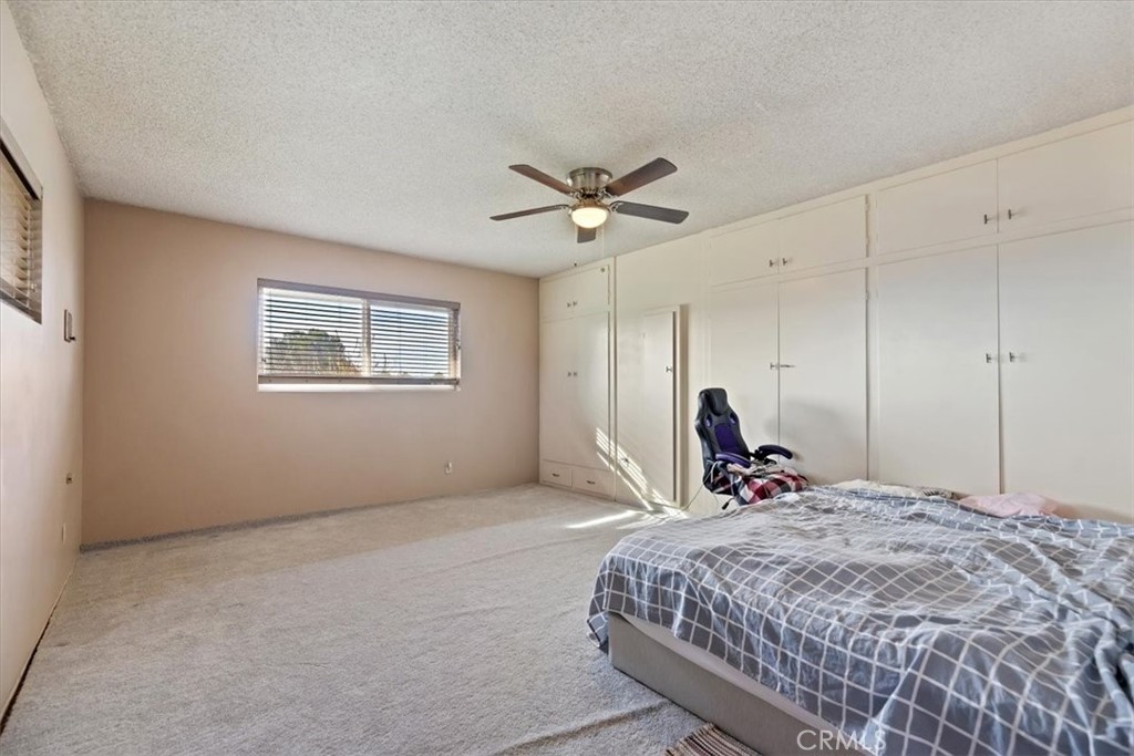 13285 Mesquite Road Apple Valley, CA 92308 - Photo 14 of 33 a bedroom with a bed and a window