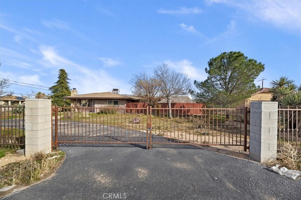 13285 Mesquite Road Apple Valley, CA 92308 - Photo 2 of 33 a view of a wrought iron fences in front of house