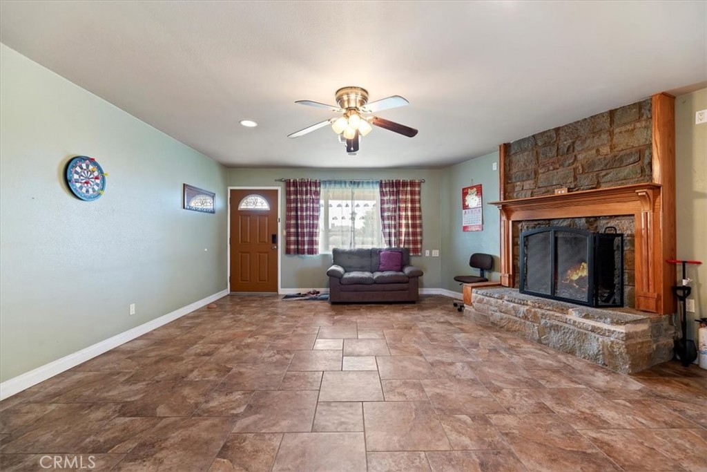13285 Mesquite Road Apple Valley, CA 92308 - Photo 3 of 33 a living room with furniture and a fireplace