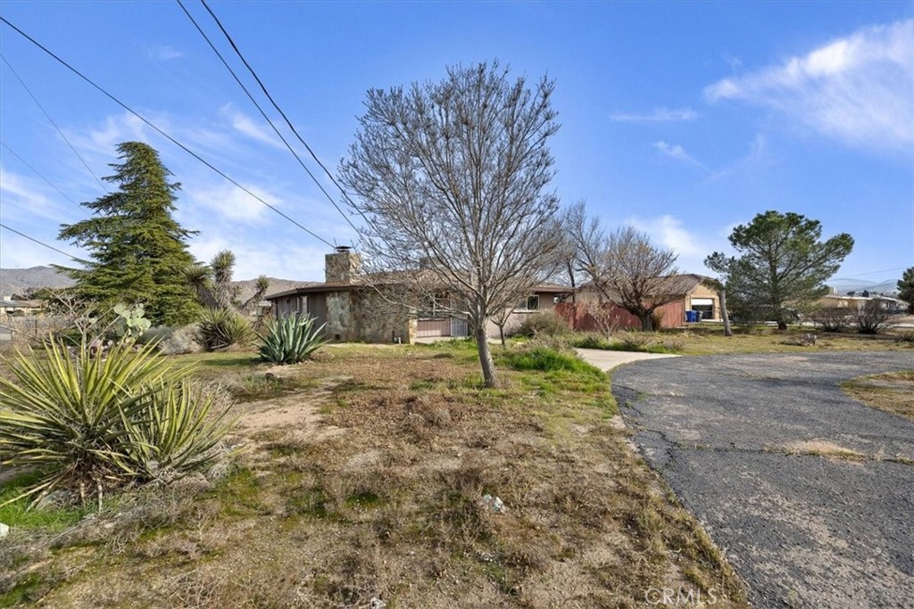 13285 Mesquite Road Apple Valley, CA 92308 - Photo 31 of 33 a view of road with large trees