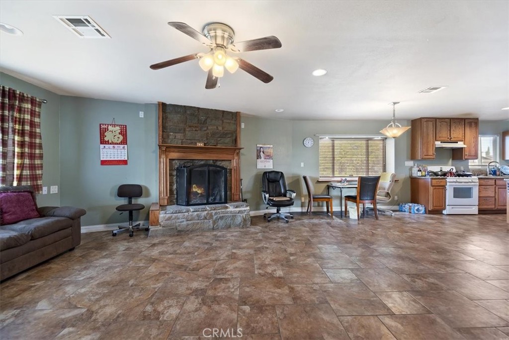 13285 Mesquite Road Apple Valley, CA 92308 - Photo 7 of 33 a living room with furniture and a fireplace
