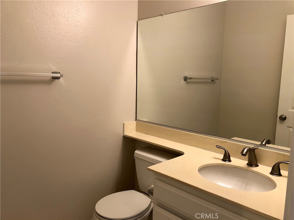 16 Prescott Irvine, CA 92620 - Photo 11 of 23 a bathroom with a sink toilet and mirror