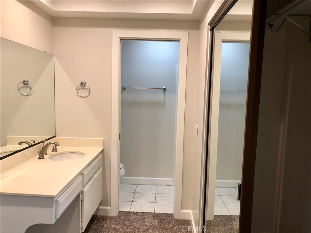 16 Prescott Irvine, CA 92620 - Photo 16 of 23 a bathroom with a granite countertop sink and a mirror
