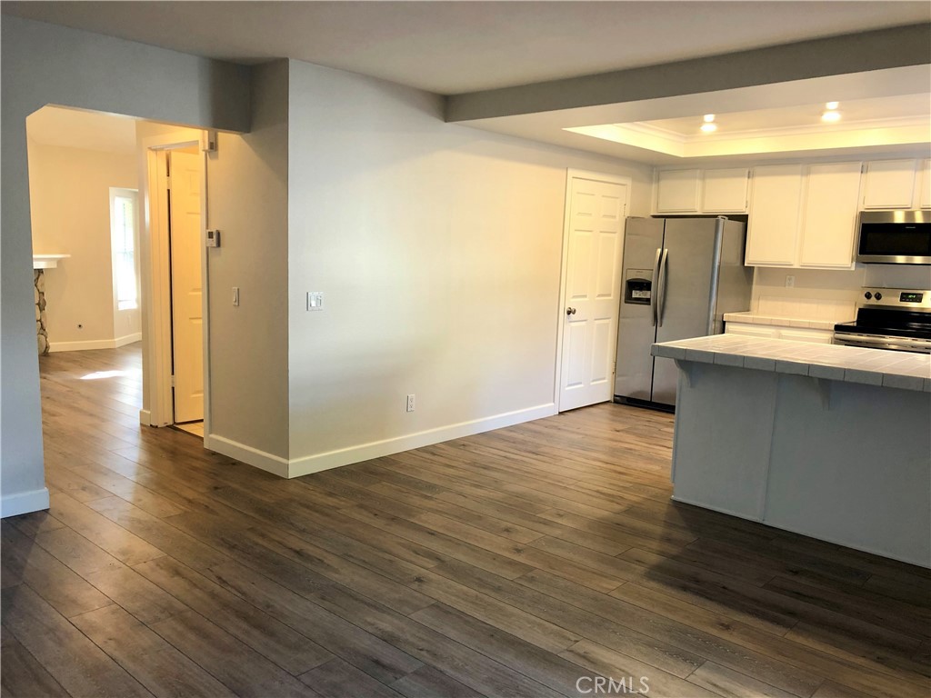16 Prescott Irvine, CA 92620 - Photo 6 of 23 a view of kitchen with stainless steel appliances wooden floor and large window