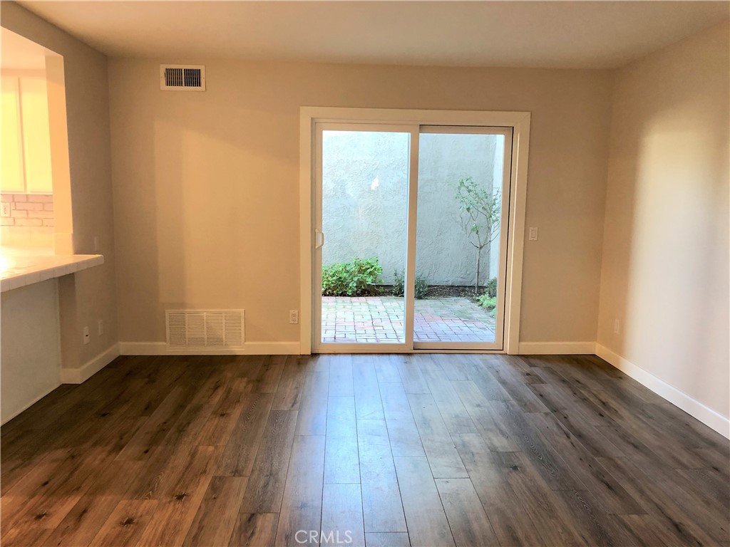 16 Prescott Irvine, CA 92620 - Photo 9 of 23 a view of an empty room with wooden floor and a window