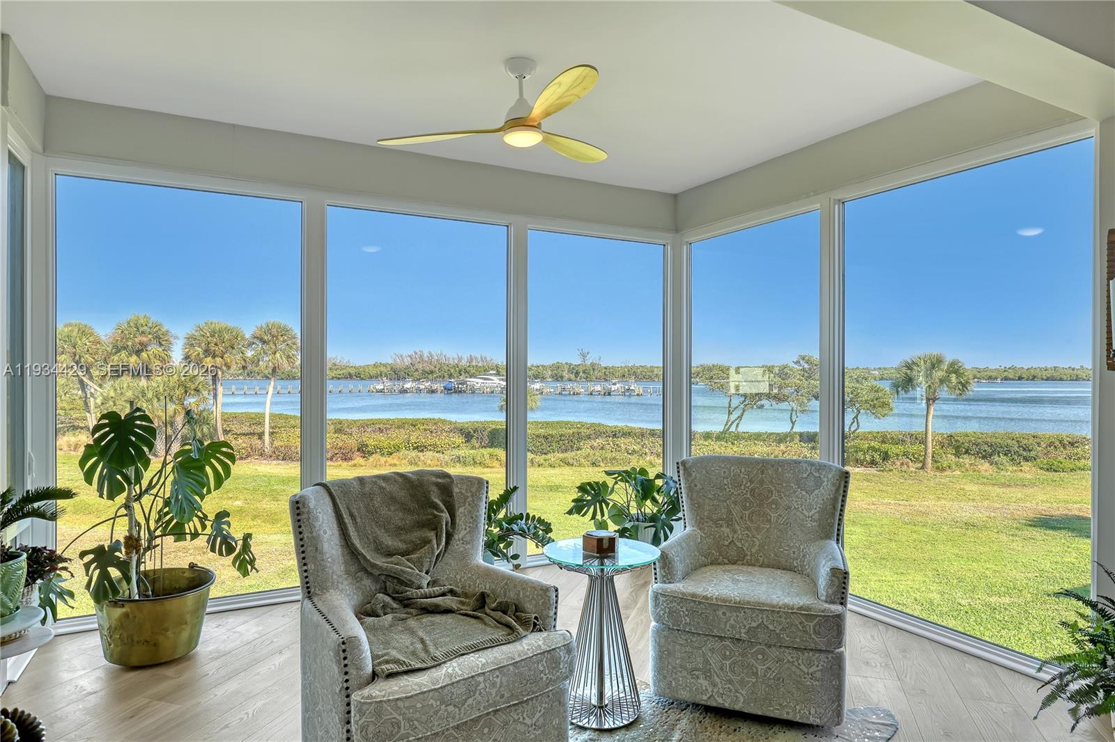 6062 Southeast Landing Way, Unit 16 Stuart, FL 34997 - Photo 11 of 35 a living room with patio furniture and a potted plant
