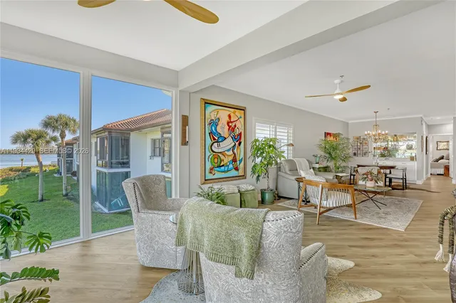 a kitchen with white cabinets stainless steel appliances and a window