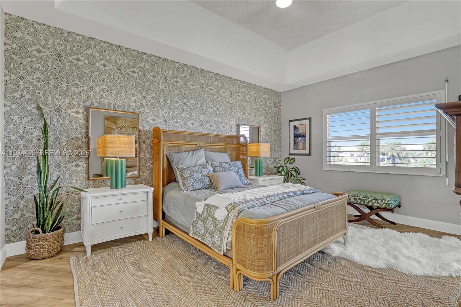 6062 Southeast Landing Way, Unit 16 Stuart, FL 34997 - Photo 19 of 35 a bedroom with a bed and windows