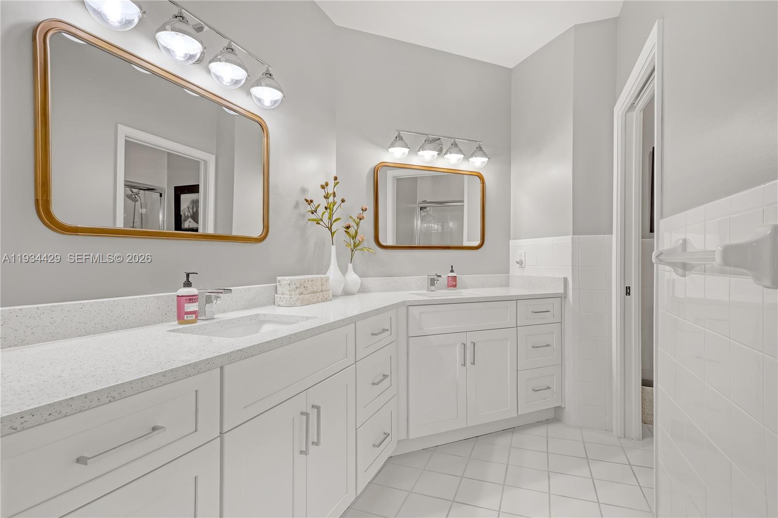 6062 Southeast Landing Way, Unit 16 Stuart, FL 34997 - Photo 23 of 35 a bathroom with a double vanity sink mirror and