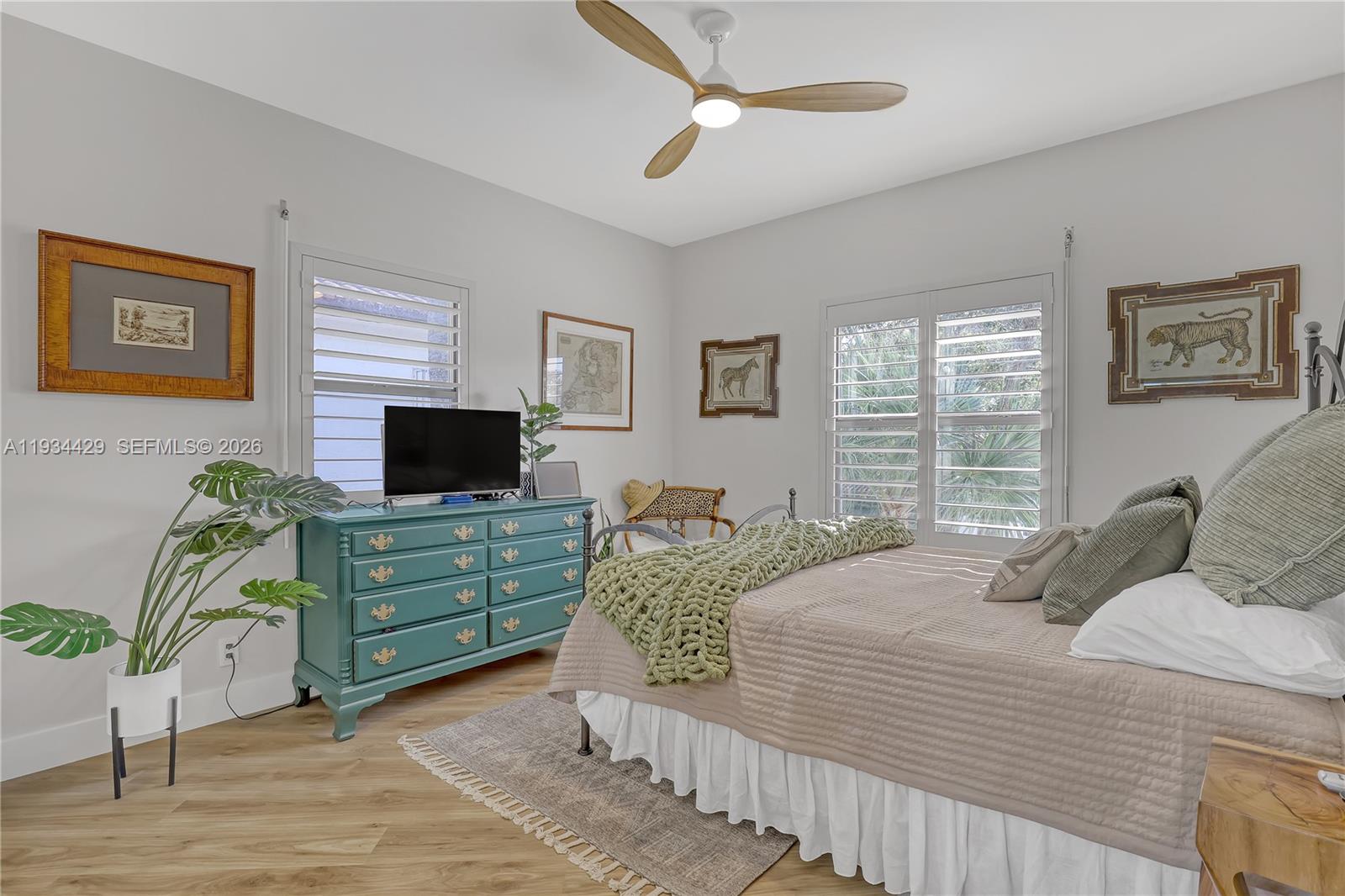 6062 Southeast Landing Way, Unit 16 Stuart, FL 34997 - Photo 25 of 35 a bedroom with a bed and a television