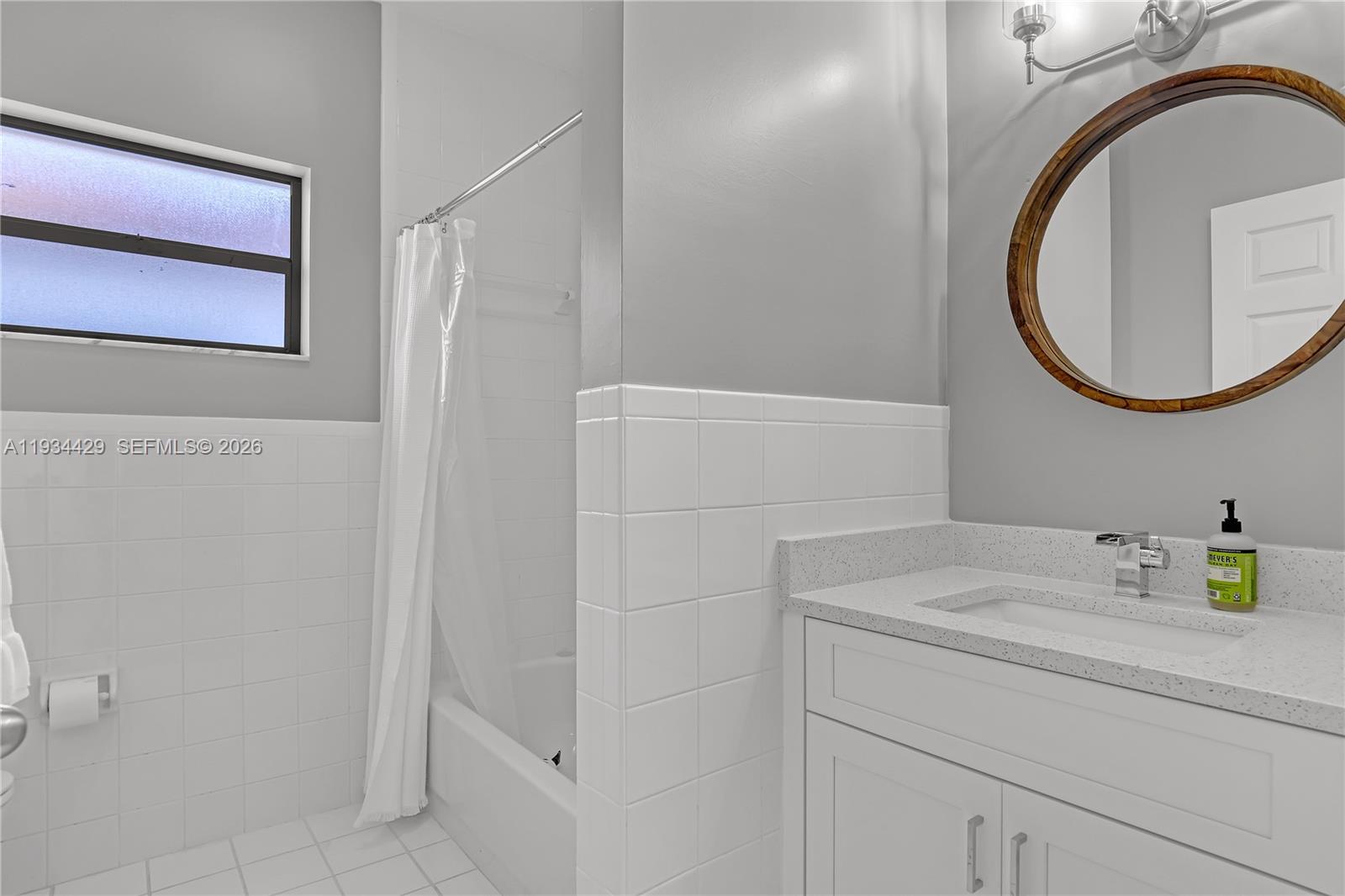 6062 Southeast Landing Way, Unit 16 Stuart, FL 34997 - Photo 27 of 35 a bathroom with a sink and a mirror