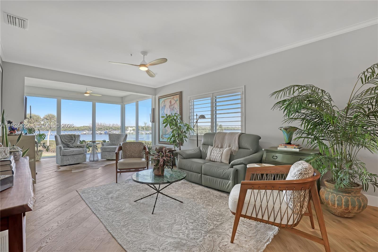 6062 Southeast Landing Way, Unit 16 Stuart, FL 34997 - Photo 6 of 35 a living room with furniture and a large window