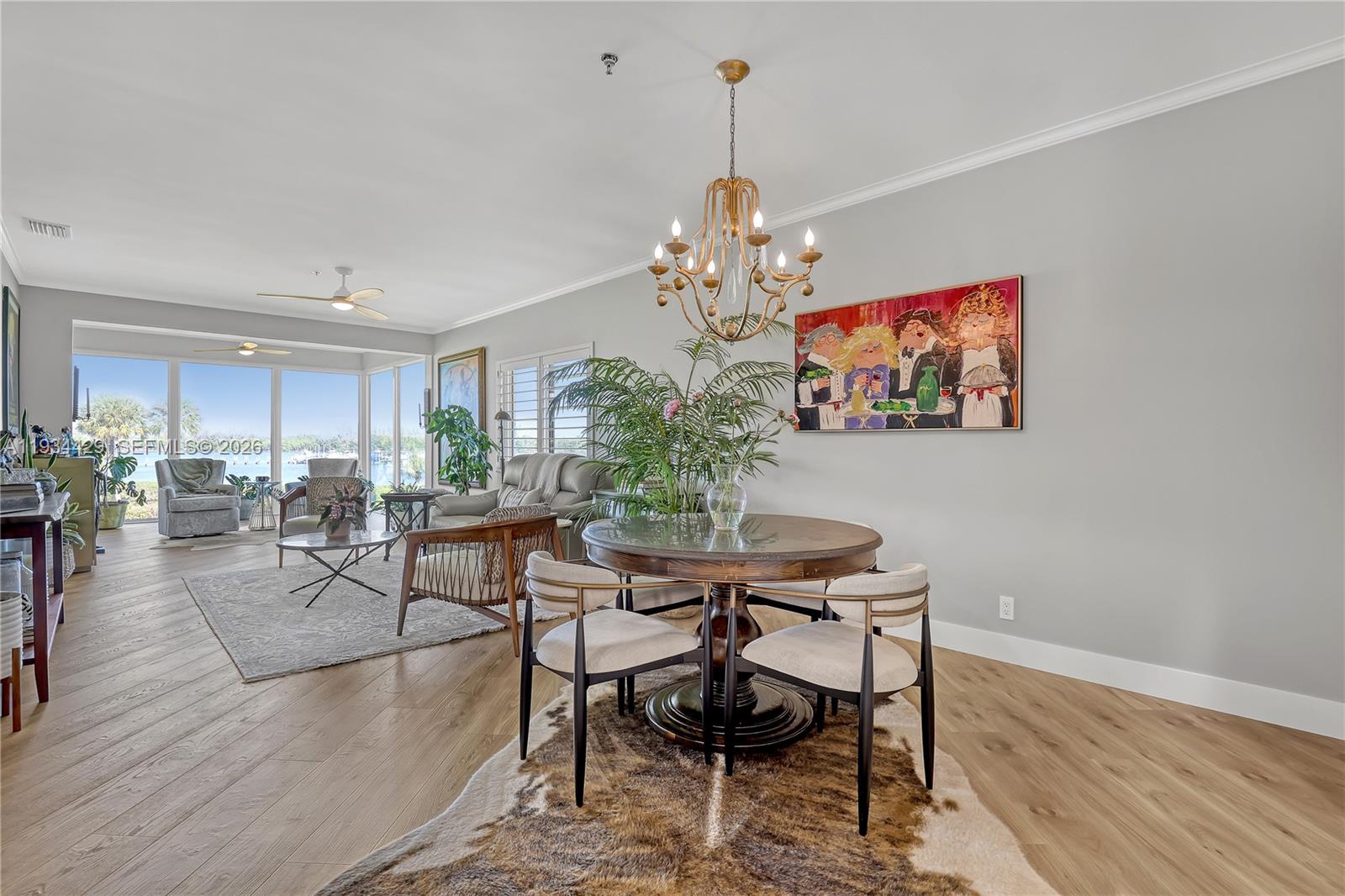 6062 Southeast Landing Way, Unit 16 Stuart, FL 34997 - Photo 7 of 35 a view of a dining room with furniture a chandelier and wooden floor
