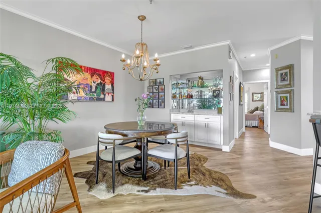a kitchen with kitchen island granite countertop a table and chairs in it