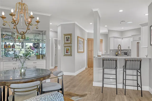 a view of a dining room with furniture and chandelier