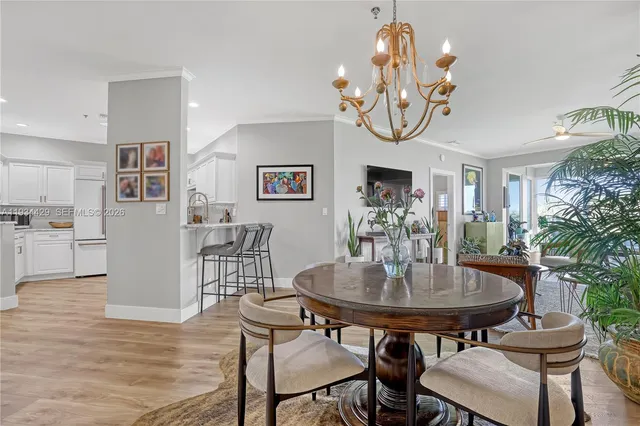 a living room with patio furniture and a potted plant