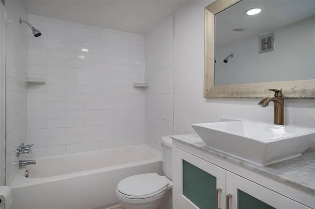 a bathroom with a sink a toilet and bathtub