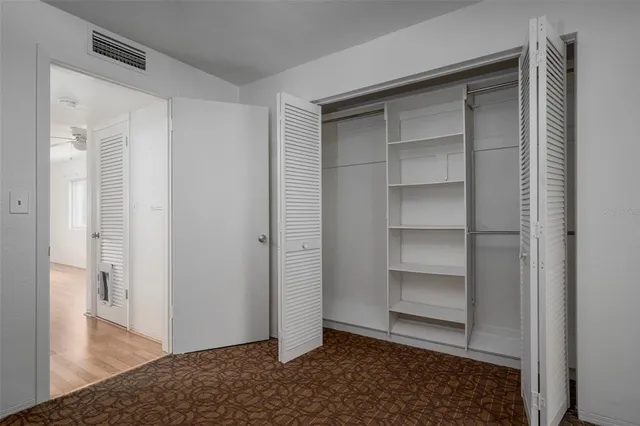 a view of an empty room and wooden floor