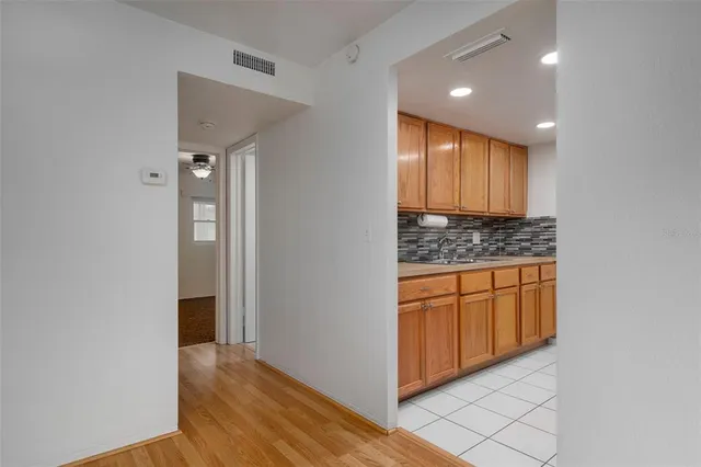 a view of kitchen with granite countertop cabinets and sink