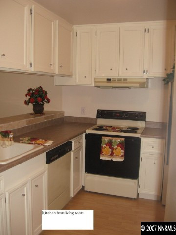 2750 Plumas Street, Unit 301 Reno, NV 89509 - Photo 5 of 7 a kitchen with stainless steel appliances granite countertop a stove a microwave and cabinets