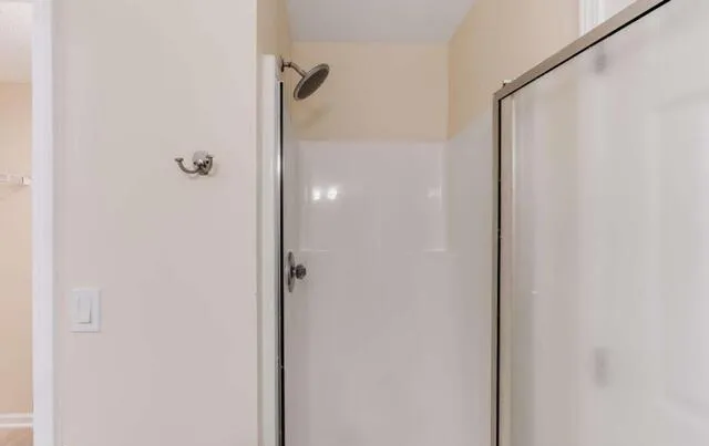 a bathroom with a glass shower door