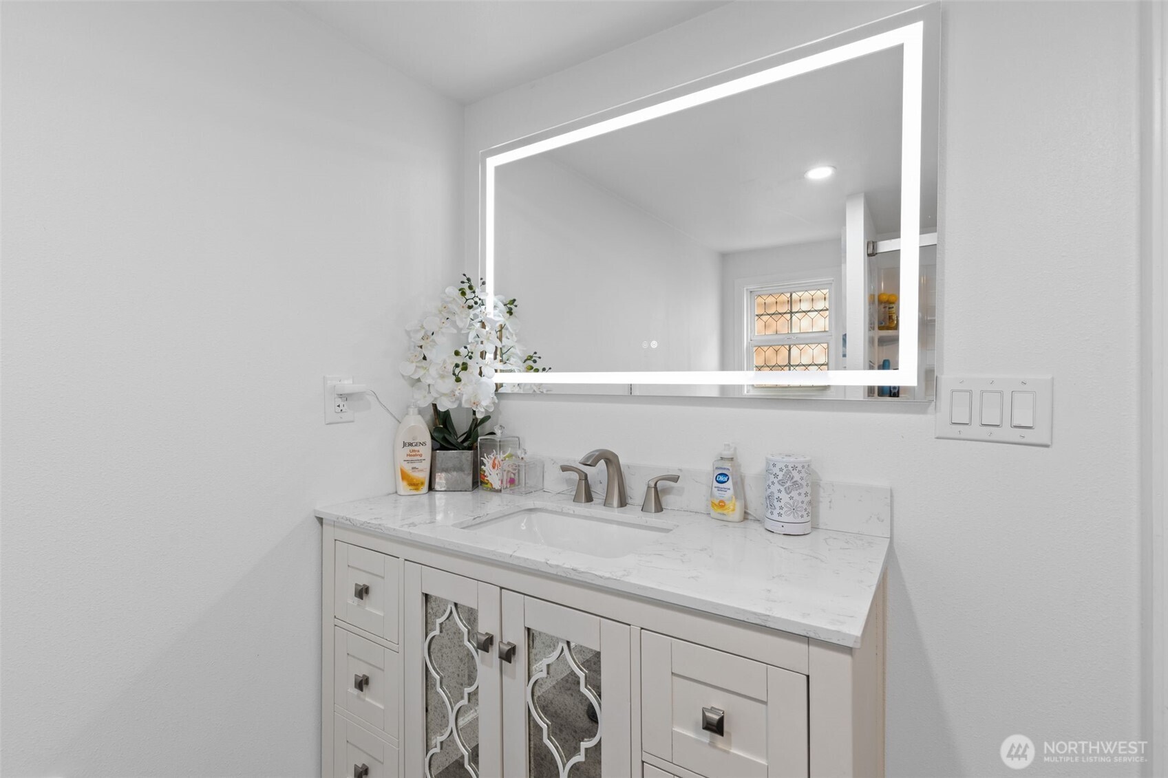 23708 Locust Way, Unit 23 Bothell, WA 98021 - Photo 15 of 24 a bathroom with a sink and a mirror
