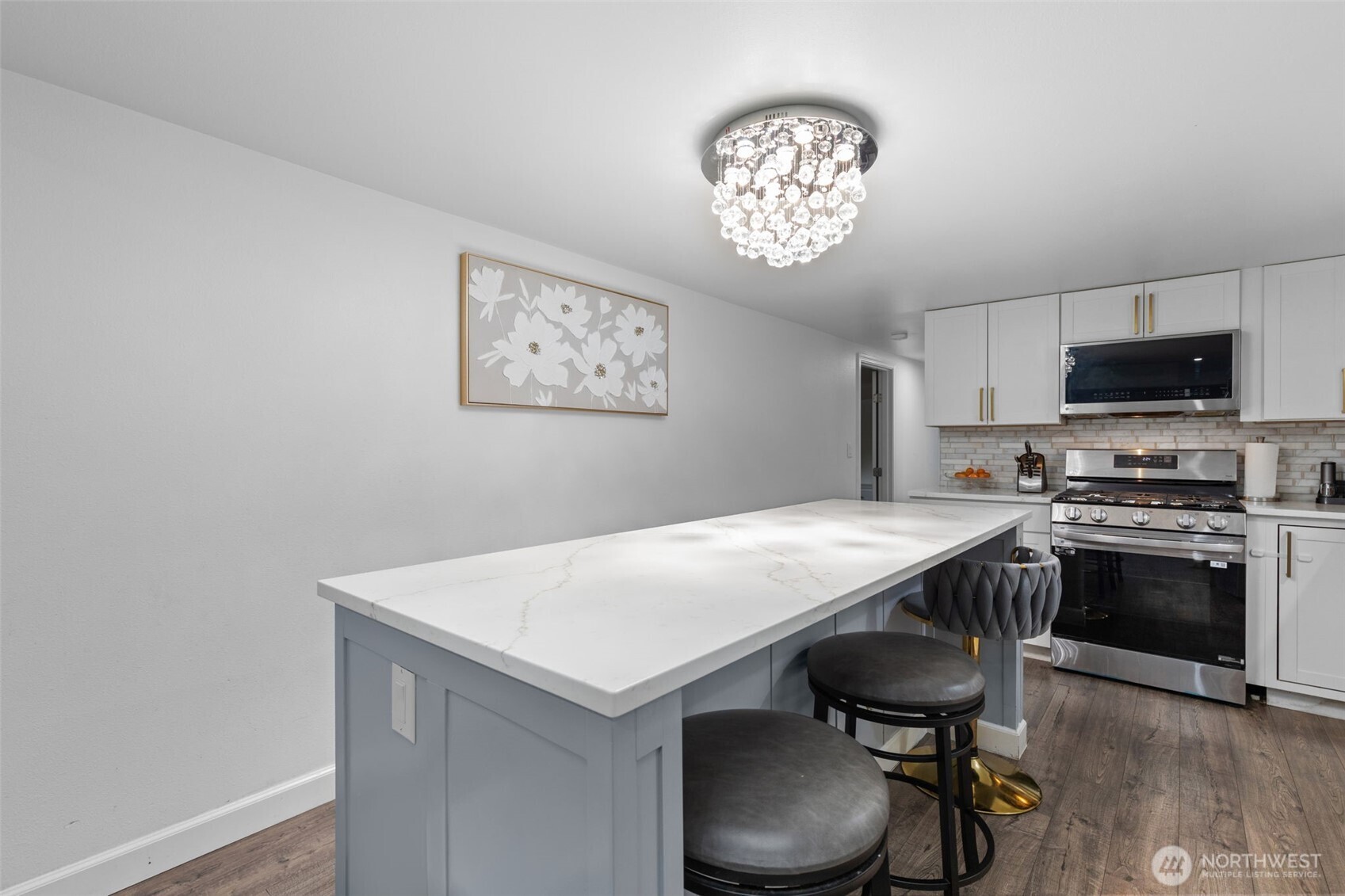 23708 Locust Way, Unit 23 Bothell, WA 98021 - Photo 6 of 24 a kitchen with a cabinets a sink and a stove with wooden floor