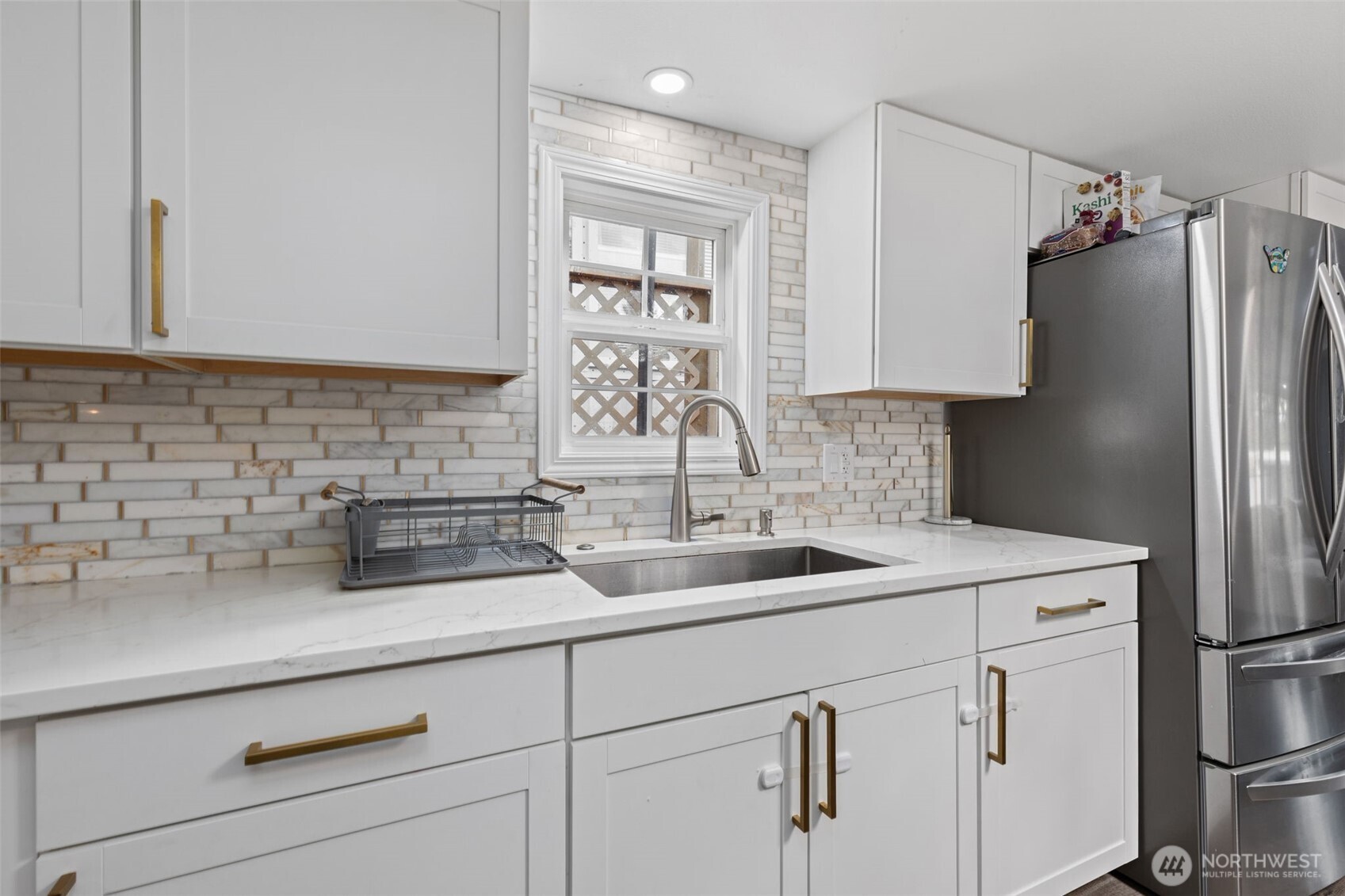 23708 Locust Way, Unit 23 Bothell, WA 98021 - Photo 8 of 24 a kitchen with white cabinets and refrigerator