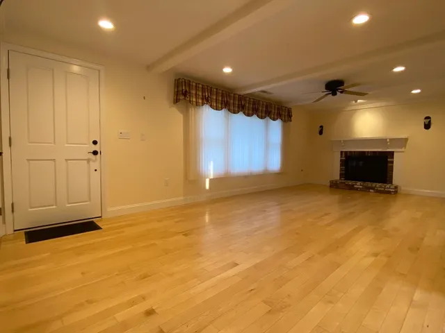 a view of an empty room with a fireplace